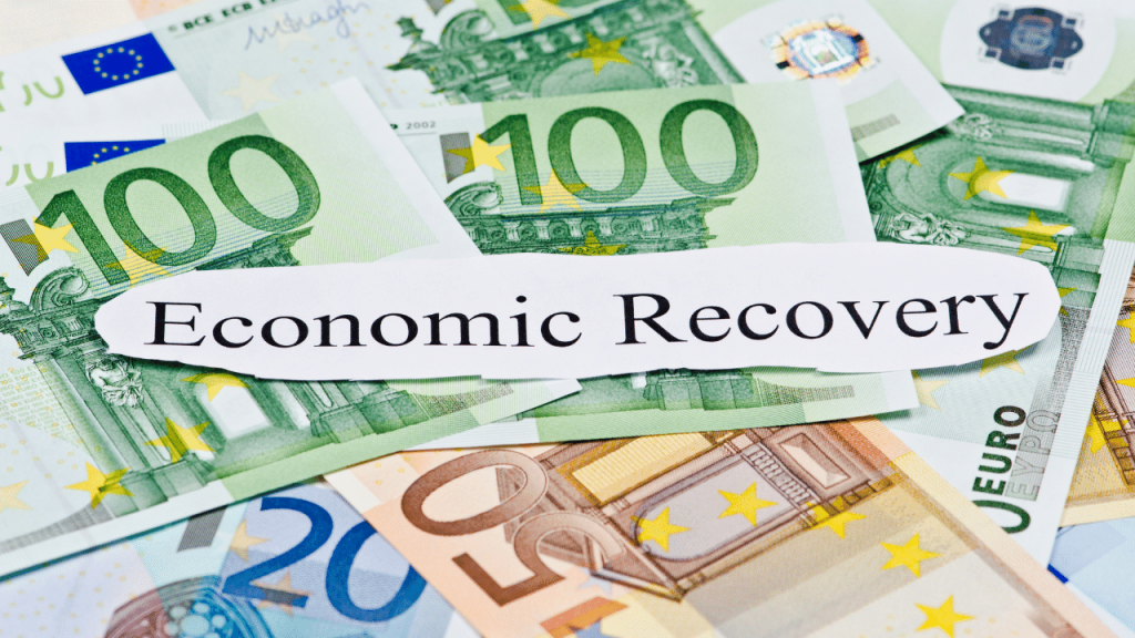 A cut-out word of "Economic Recovery" is on top of Euro bills 